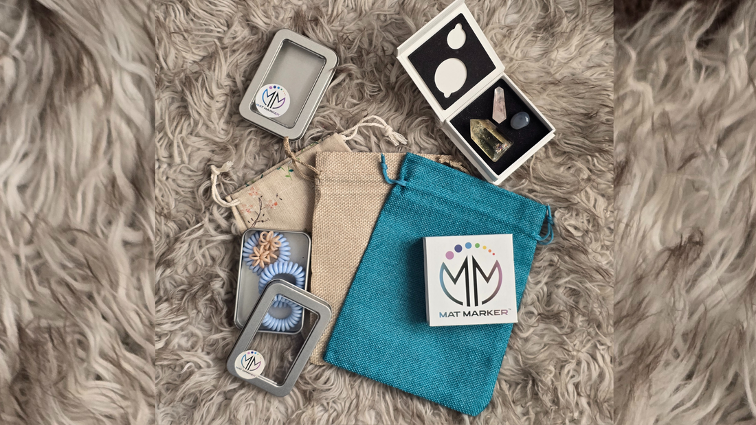 Reusable packaging from Mat Marker; a tine, a white magnetic box and small burlap gift bags. Eco friendly yoga mat charm packaging
