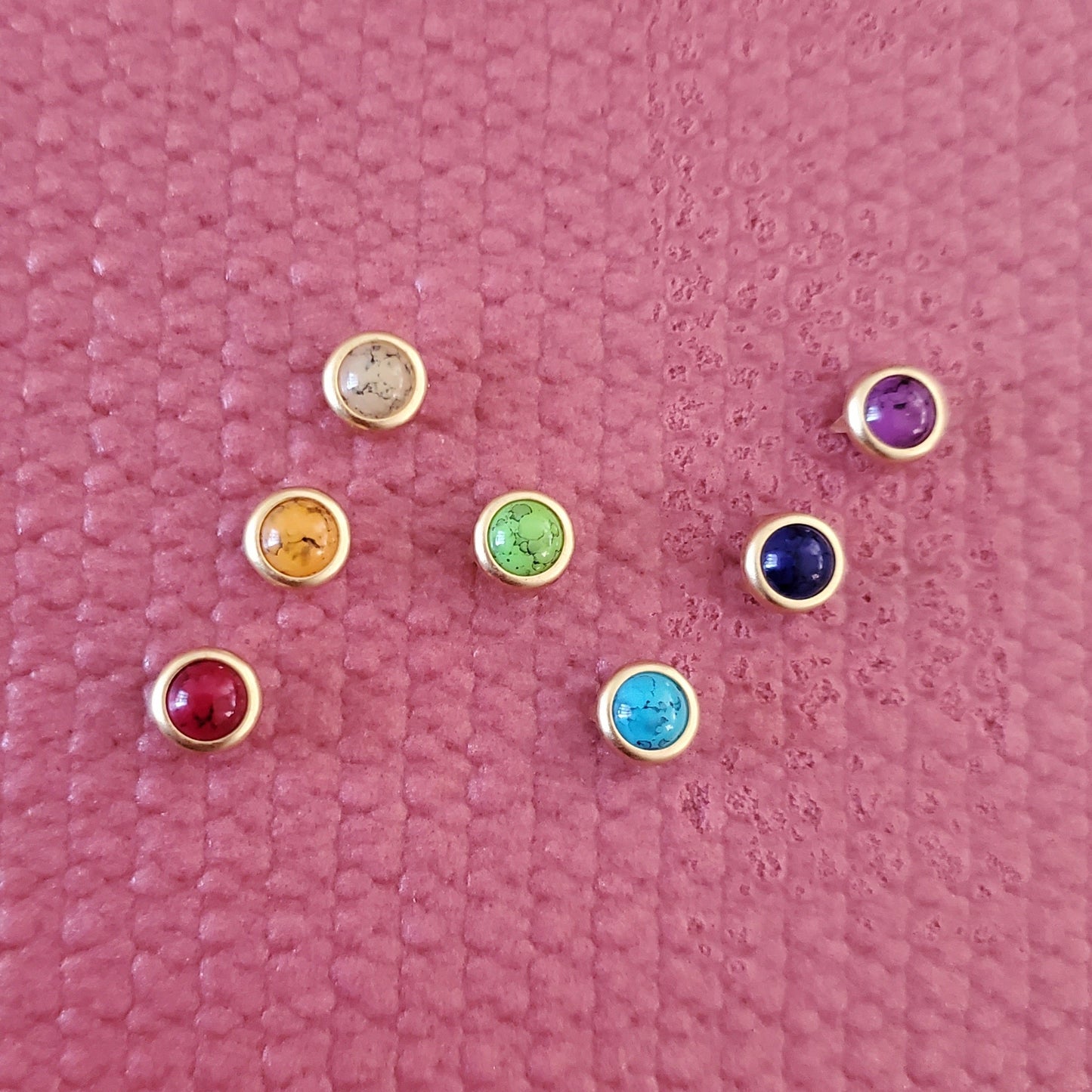 Set of colorful gemstone yoga mat charms installed in on a pink yoga mat