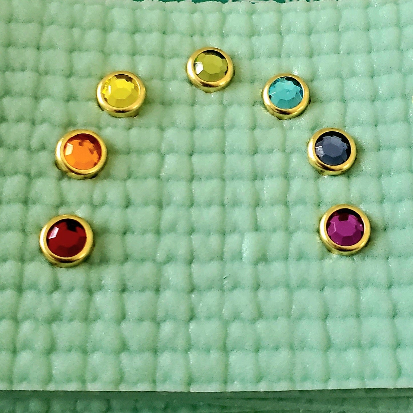 yoga mat charm gems on a yoga mat, rainbow design and colors