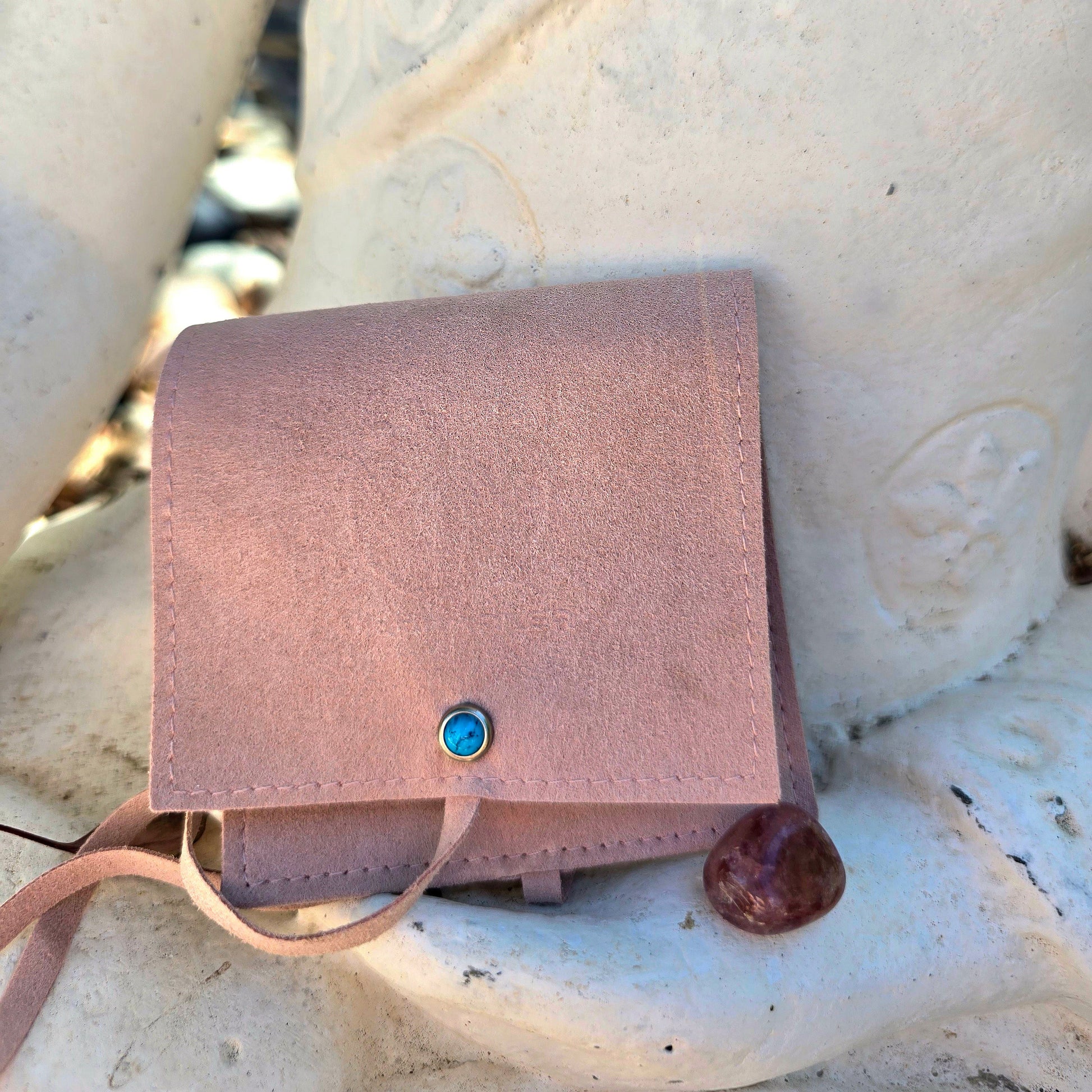 make your mark crystaal pouch with a small stone on the front